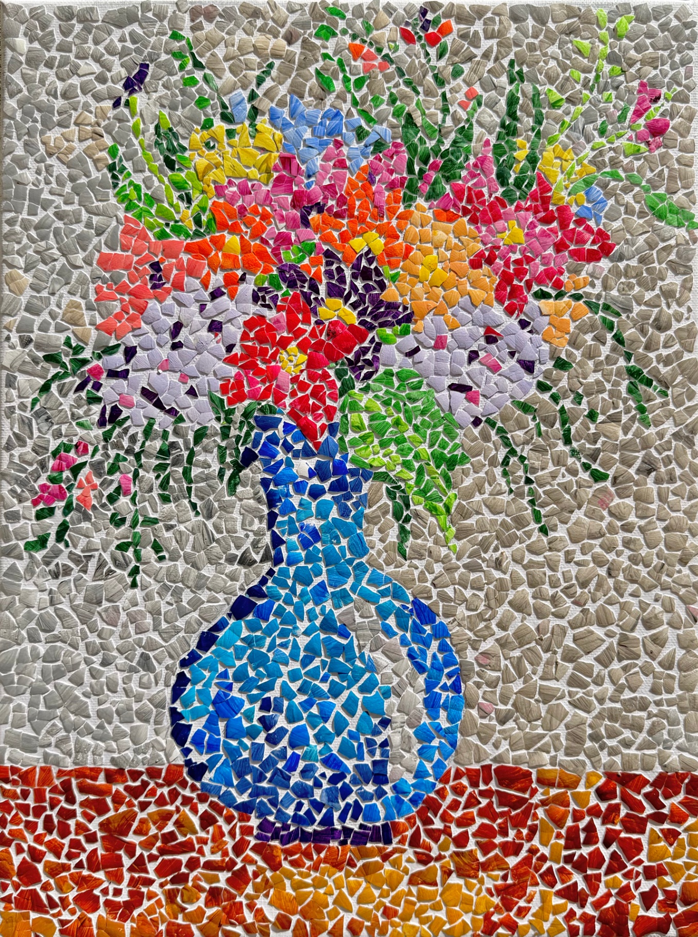 Eggshell mosaic still life of a vibrant bouquet of wildflowers in a blue vase on a red tabletop