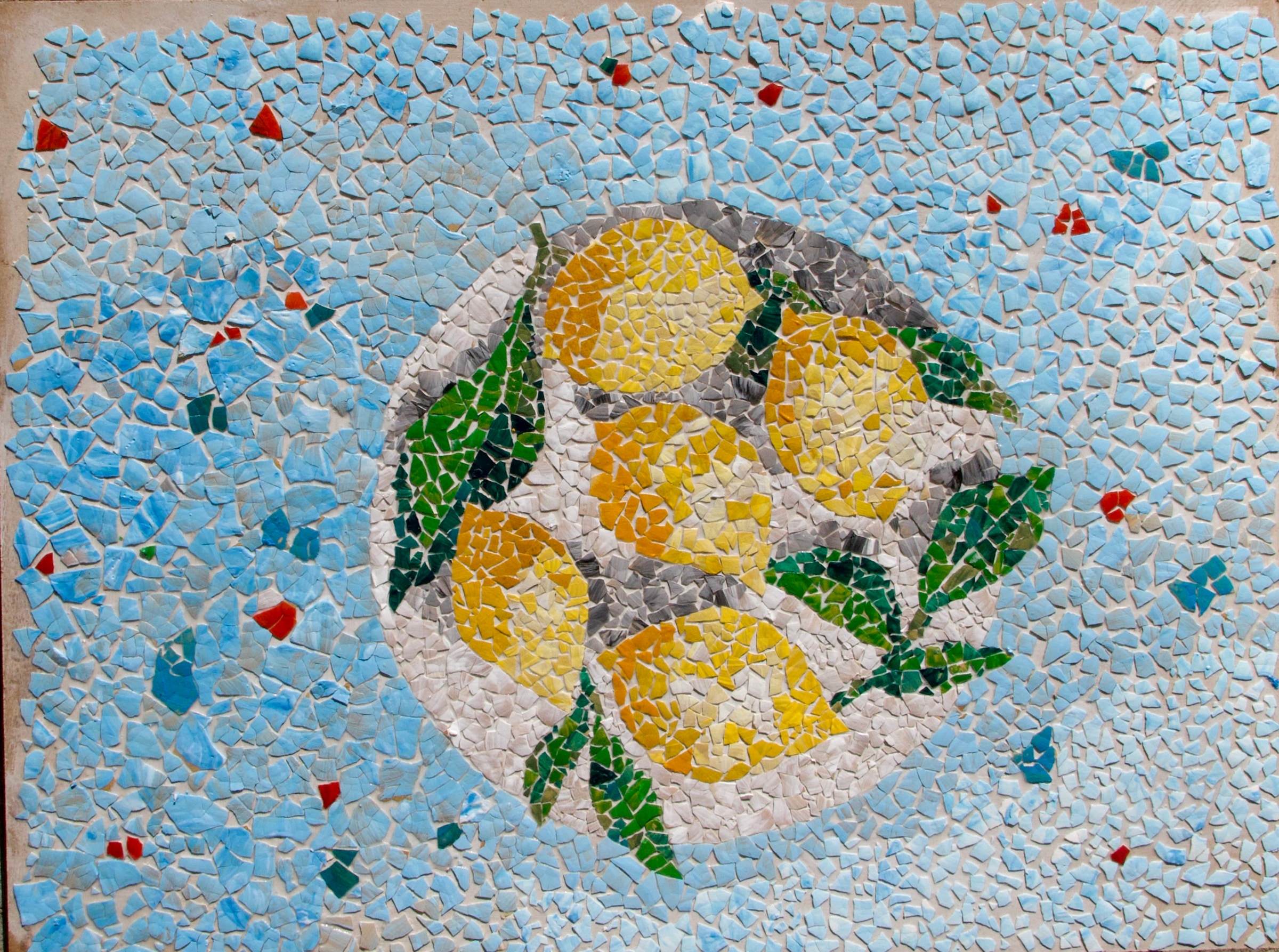 Eggshell mosaic of yellow lemons heaped in a bowl on a cobalt blue ground with red accents